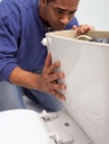 handyman looking at toilet